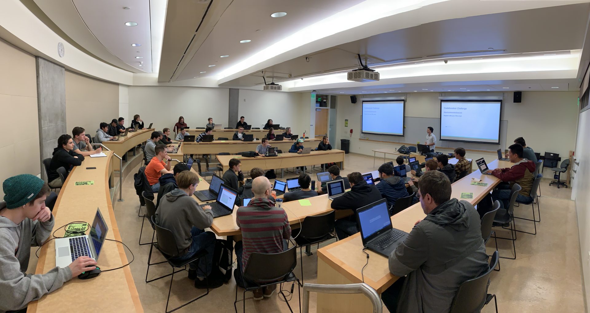 Photo of classroom full of students, many of which have laptops out