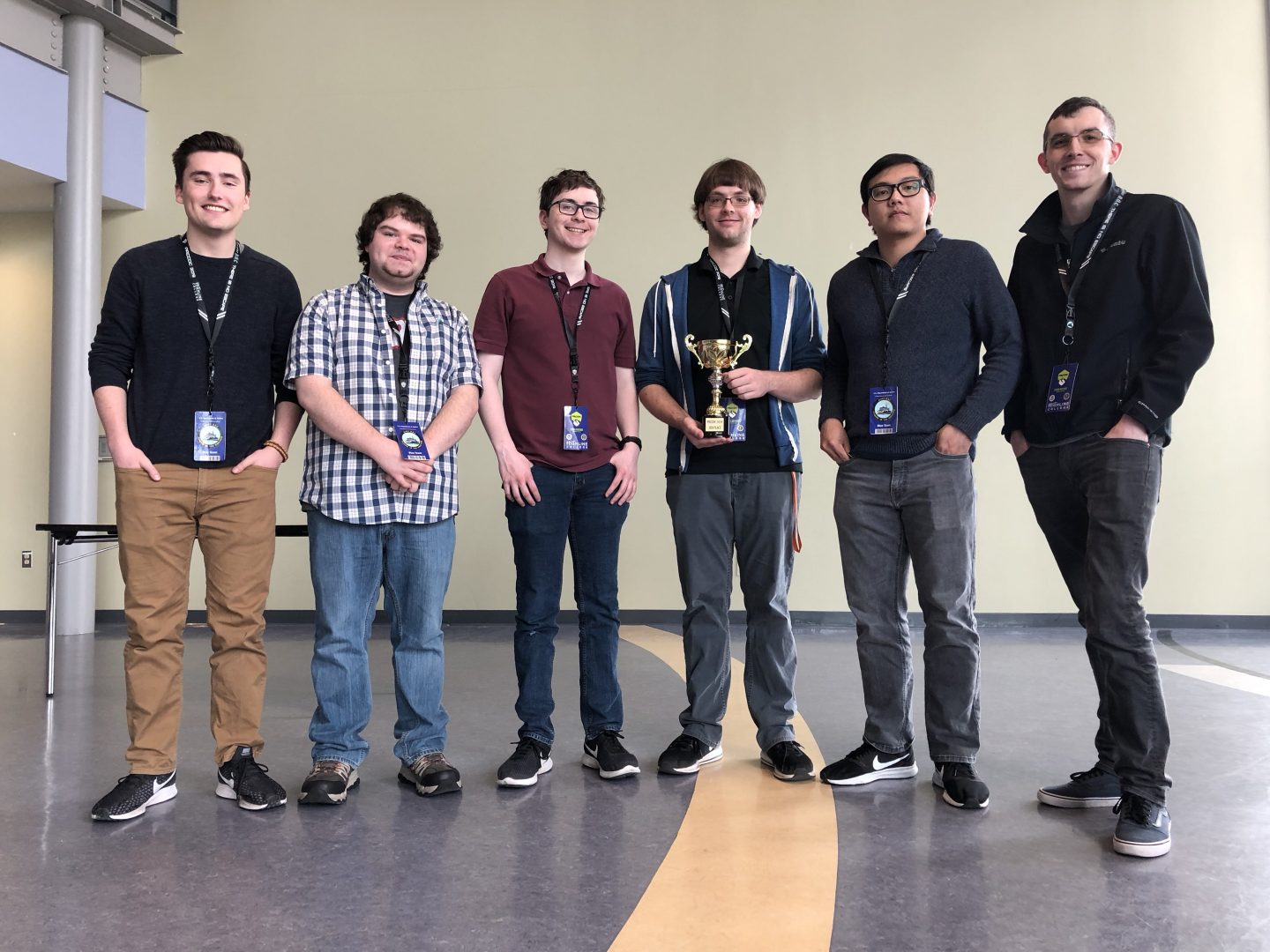 Victory photo of 6 OSUSEC students, with one holding a trophy